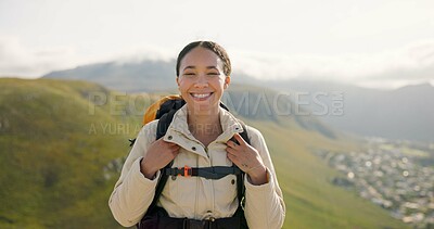 Happy woman, face and backpack with mountain for hiking, adventure or outdoor journey in nature. Portrait of female person, tourist or hiker smile with bag for trekking or climbing on cliff or hills