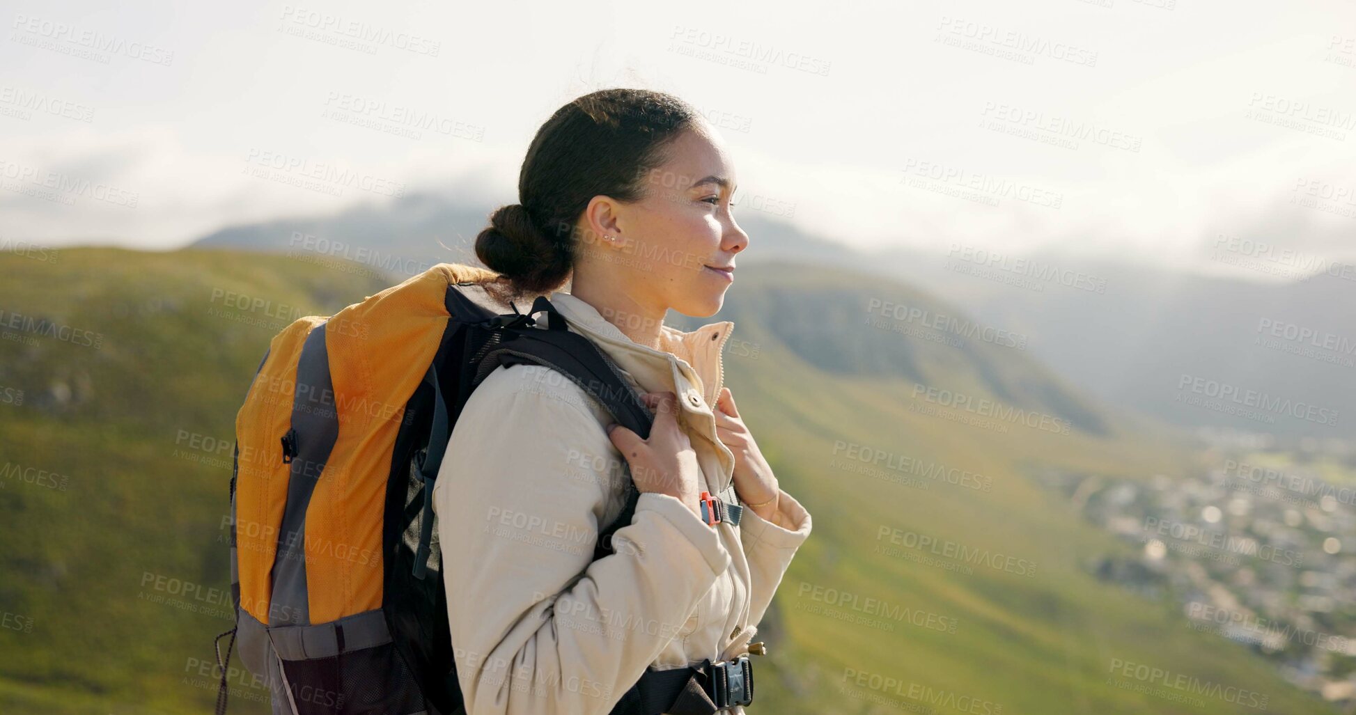 Buy stock photo Young woman, trekking on mountains and breathing fresh air for outdoor wellness, fitness and health. Happy person in wind with backpack and hiking in nature on a hill for adventure, travel or journey