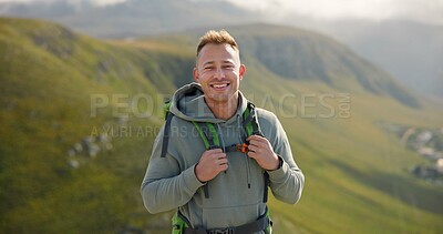 Happy man, face and backpack with mountain for hiking, adventure or outdoor journey in nature. Portrait of male person, tourist or hiker smile with bag for trekking or climbing on cliff or hills