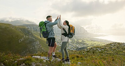 Couple, high five and hiking on mountains for success, support and travel achievement or goals in nature. Happy people hug with love for outdoor journey and trekking in backpack on eco friendly hills