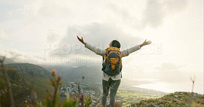 Woman, mountain top and freedom or success for hiking goals, travel or trekking adventure in nature. Back of hiker or winner in backpack and arms up for celebration, achievement or excited on a cliff
