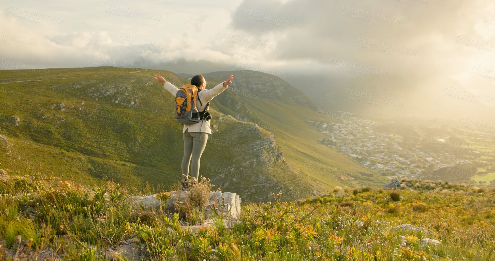 Buy stock photo Woman, mountain top and freedom, hiking goals, celebration or travel achievement in nature adventure. Person or winner in backpack with arms up for trekking success, energy and yes on a cliff or rock