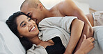 Happy couple, relax and kissing on bed for embrace, love or morning romance in trust or care at home. Young man and woman smile lying in bedroom hug for intimacy, passion or bonding together at house