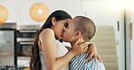 Couple, hug and kissing for love at home, happy and support in marriage and embrace for romance. People, spin and bonding together for relationship, lovers and commitment or loyalty in apartment