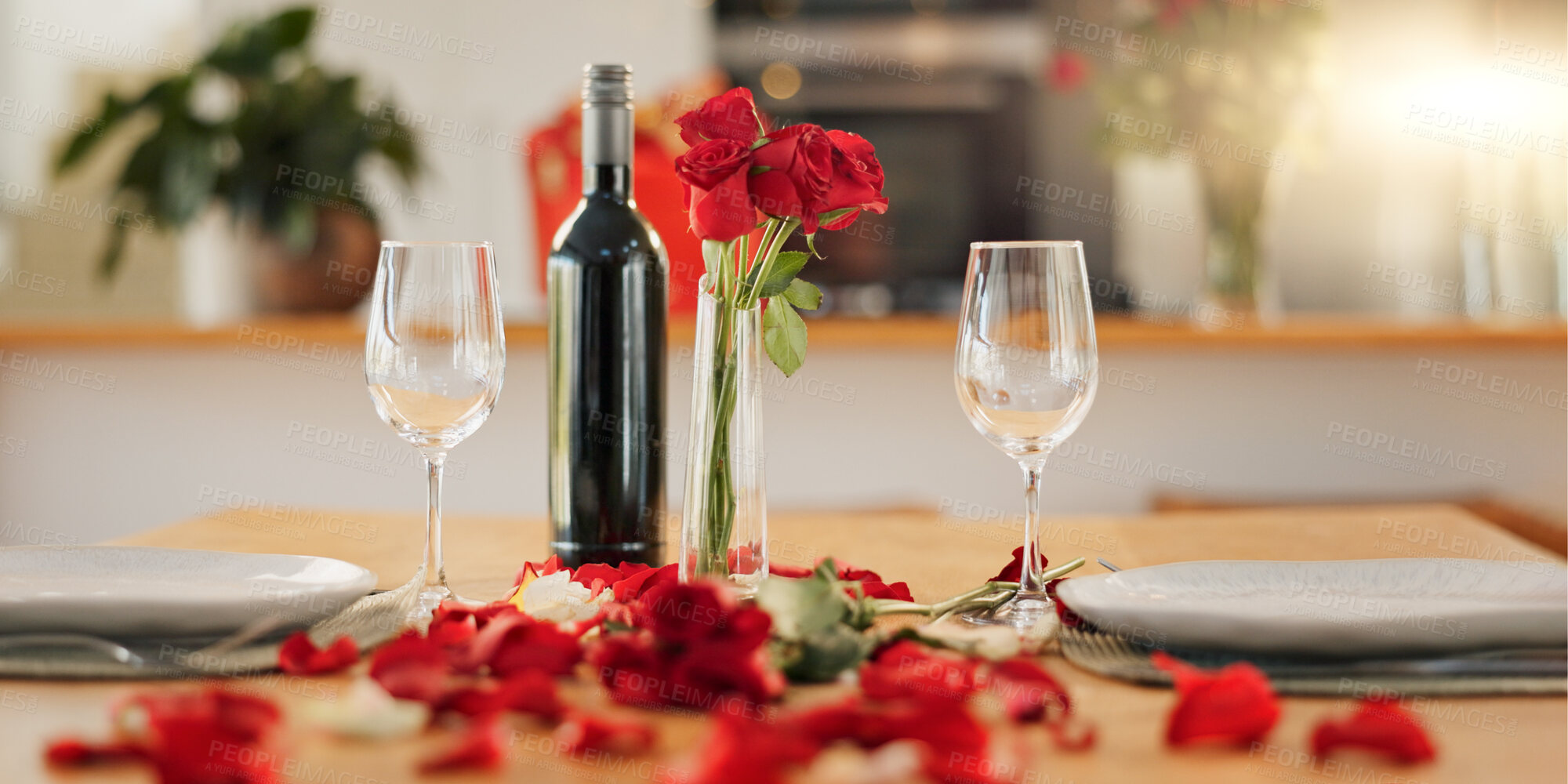Buy stock photo Wine, flowers and romance on valentines day for celebration of love, anniversary or honeymoon in still life. Glass, dinner and elegant date in dining room of home for event, milestone or occasion
