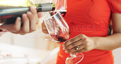 Couple, hands and bottle of red wine for celebration of love, romance and valentines day on their anniversary. People or lover on date with glasses, drinks and alcohol for toast, success and luxury