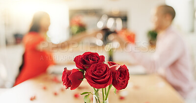 Couple, roses and toast at home with wine glass for celebration of love, romance and valentines day. People cheers for date success, drinking red champagne and luxury dinner at a table with flowers