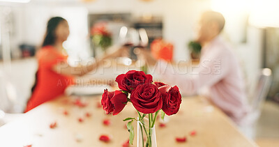 Couple, roses and toast at home with wine glass for celebration of love, romance and valentines day. People cheers for date success, drinking red champagne and luxury dinner at a table with flowers