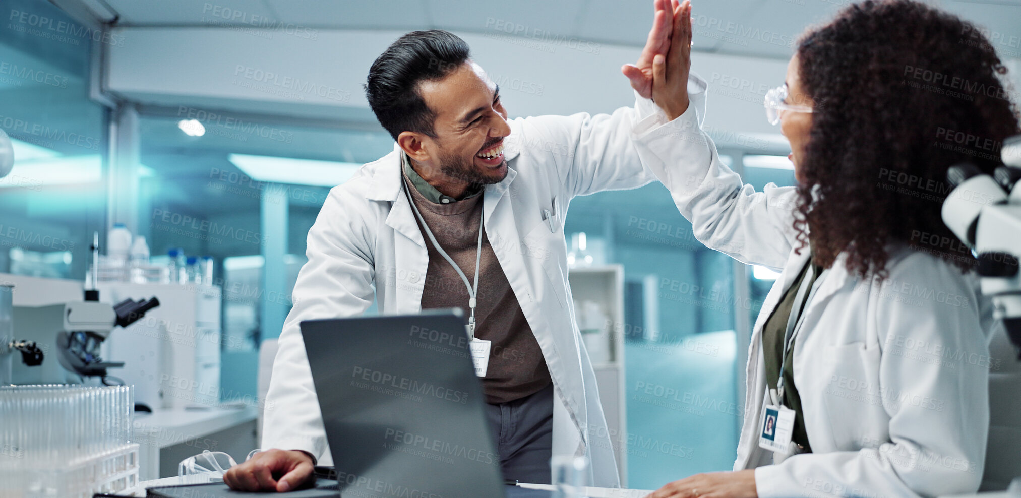 Buy stock photo Scientist, teamwork and high five with laptop in laboratory for test breakthrough, pharmaceutical review or success. Science, collaboration or technology for research, discussion and digital analysis