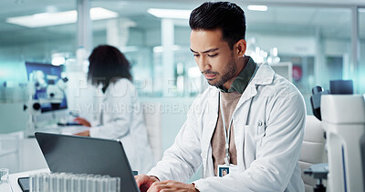 Laptop, man or scientist typing to research in laboratory for a chemistry report or medical test feedback. Internet, person reading or science update for online medicine development news on website