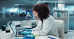 Scientist, woman and typing on laptop with test tube for chemistry, research or experiment at lab. Science, computer and serious medical professional in development of cure, biotechnology or study