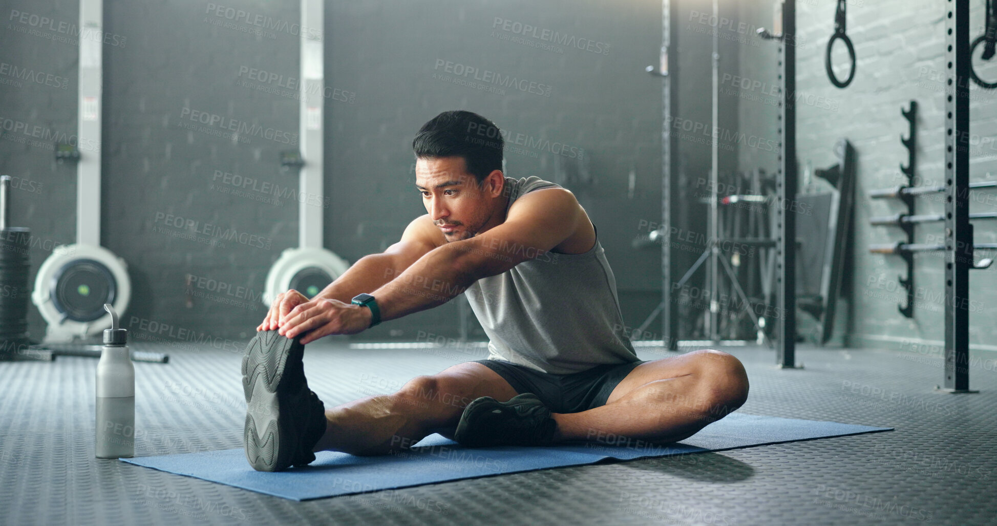 Buy stock photo Man, break and stretching on gym floor in fitness, workout or training for strong muscles, heart health or cardio wellness. Japanese personal trainer, sports person or coach in body warmup exercise