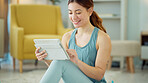 Fitness, internet and woman streaming on a tablet for training, yoga and exercise on the floor of her house. Happy, young and wellness girl with technology for a workout, cardio or video on pilates