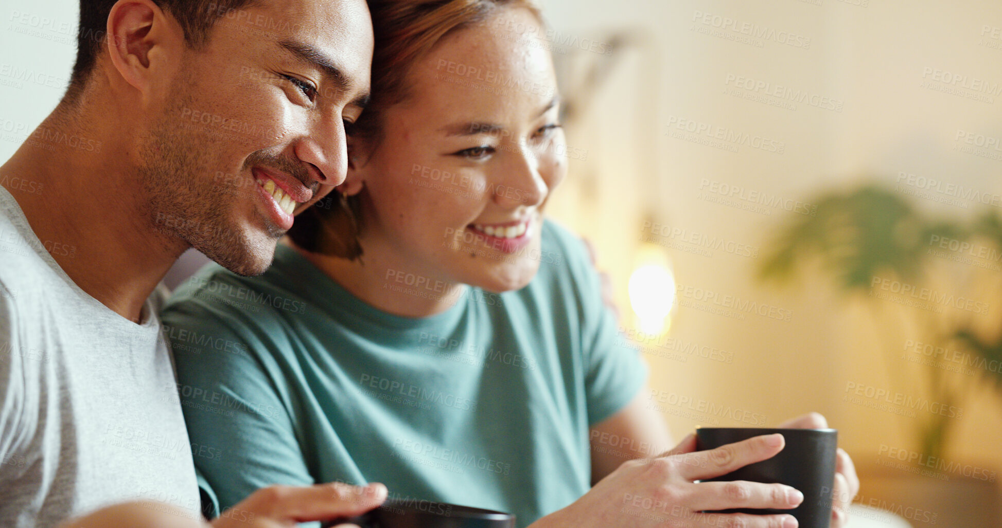 Buy stock photo Happy, coffee and laughing asian couple bonding and having fun spending time together at home. Comic, funny and content man and woman drinking tea enjoying free time at home and laugh at comedy joke