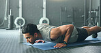 Fitness, man and pushups for muscle, exercise or training workout for strength or power at the gym. Athletic male in sport exercising lifting body with arms on the floor for strong muscles indoors