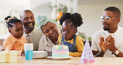 Birthday, children party and applause with a family in celebration of a girl child in their home. African parents, grandparents and kids clapping while blowing candles on a cake at a milestone event