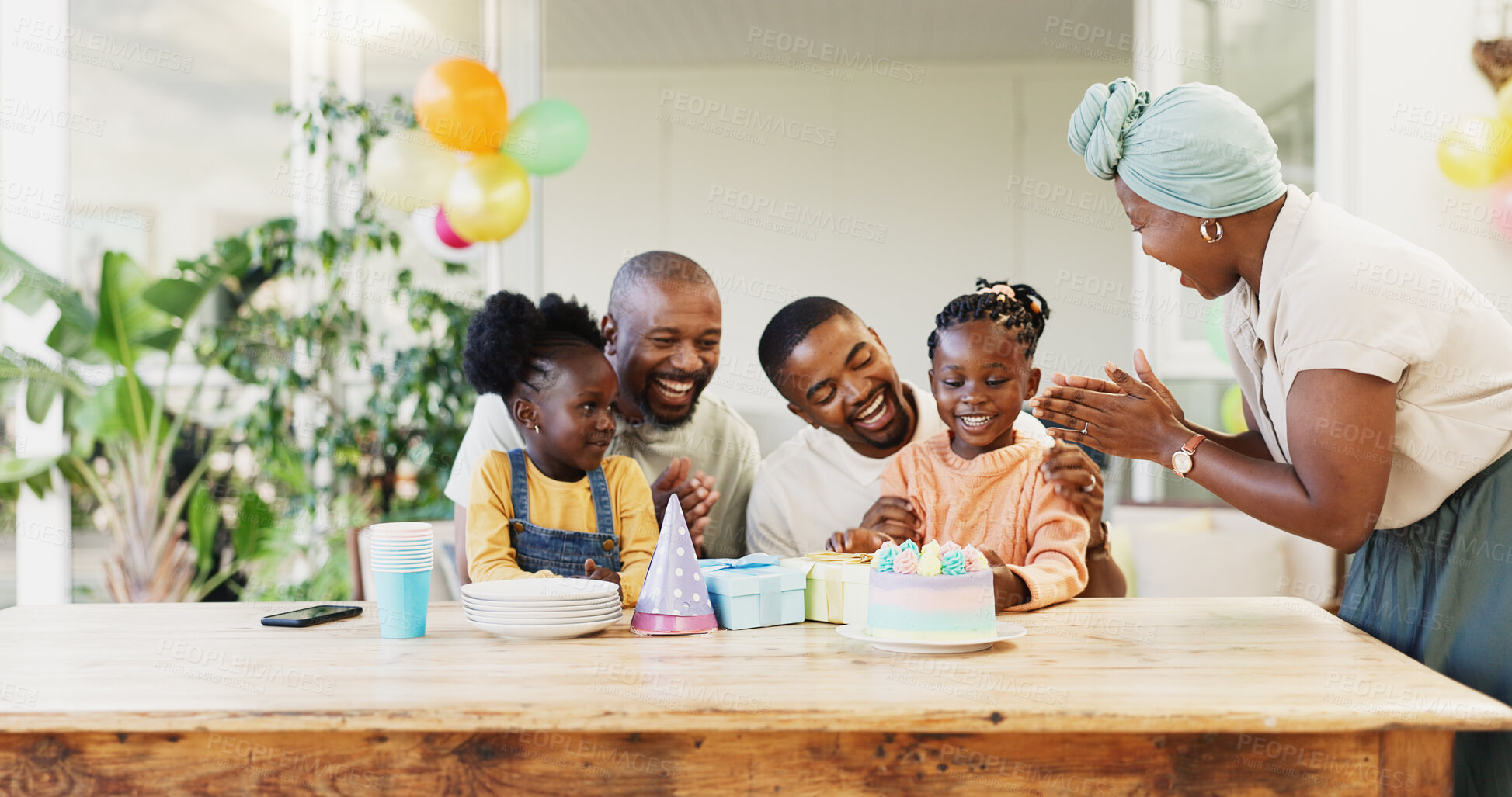 Buy stock photo Birthday cake, family and children with parents for celebration, clapping and cheers for party at home. Happy, excited people, girl or kids with dessert and singing, kiss and love or support on patio