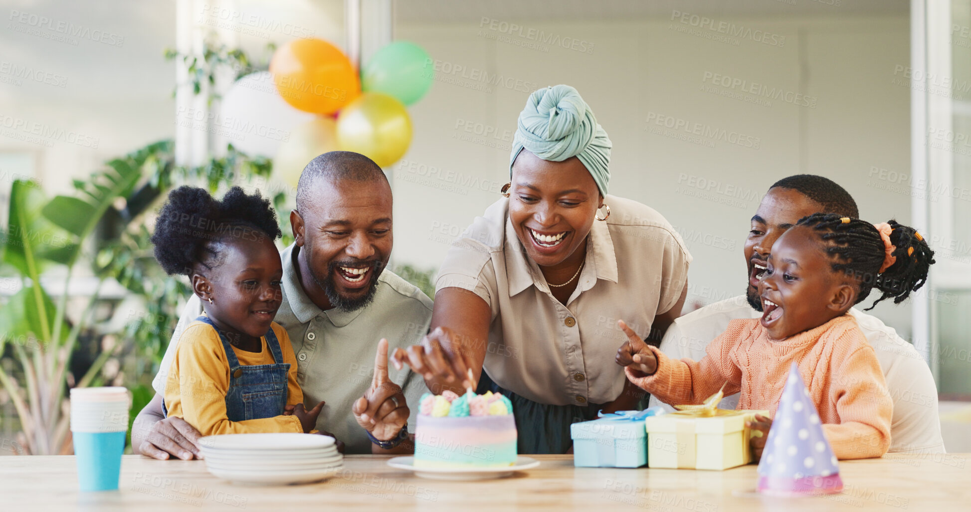 Buy stock photo Black family, birthday cake and candles for children to celebrate with parents at a table. African woman, men and happy kids at home for a party, quality time and bonding or fun with love and care