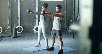 Exercise, black woman and man with kettlebell, fitness and workout for health, wellness and in gym. Healthy couple, gym equipment and doing training with stretching, routine and focus in sportswear.
