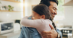 Children, father and daughter hug in the kitchen for love, trust or bonding together in their home. Family, smile and safety with a happy young man embracing his adorable girl child in their house