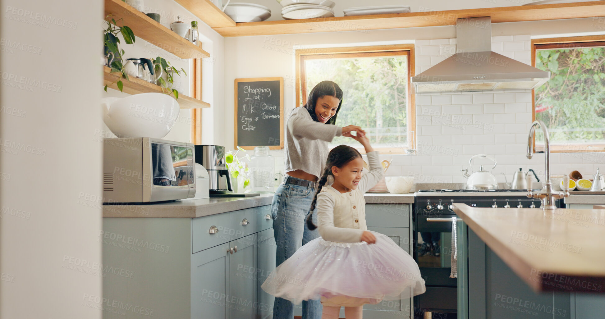 Buy stock photo Dance, ballet and girl with mother in a kitchen together or mom support child and playing as a dancer or ballerina. Tutu skirt, mommy and woman dancing, bonding or spin with kid in house or home