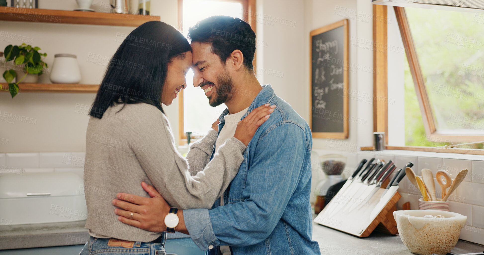 Buy stock photo Love, hug and couple in a kitchen happy, together and intimate while bonding in their home. Embrace, romance and man with woman hugging, smile and sharing moment of trust, care or soulmate connection