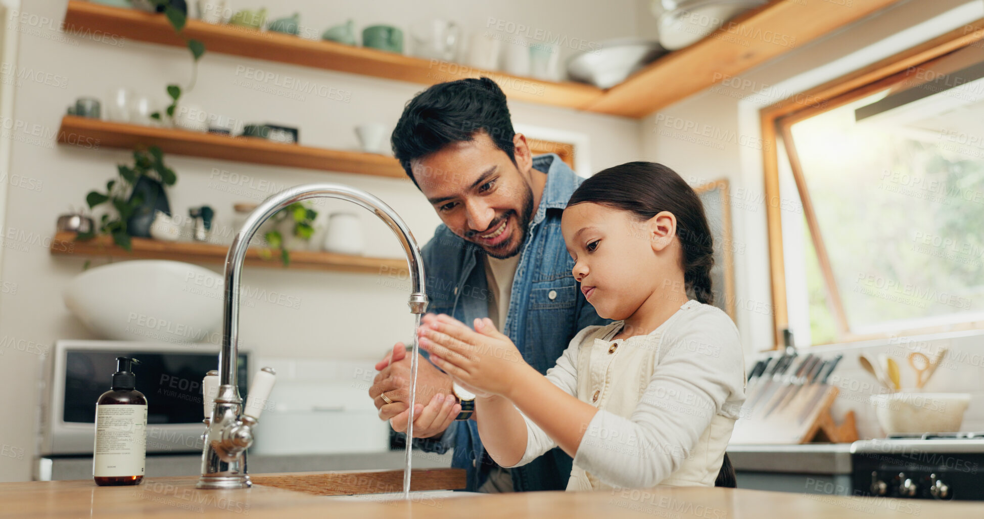 Buy stock photo Girl washing her hands with her father in the kitchen for hygiene, health and wellness at home. Child learning to clean her skin with young dad with soap and water to prevent germs, dirt or bacteria.