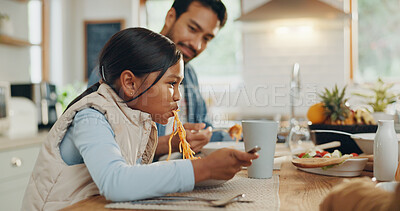 Father, kids and a girl eating spaghetti with her family in the dining room of their home together for supper. Food, children and parents around a table for a meal, bonding over dinner in a house