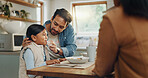 Parents, children and a girl eating spaghetti with her family in the dining room of their home together for supper. Food, kids and father around a table for a meal, bonding over dinner in a house