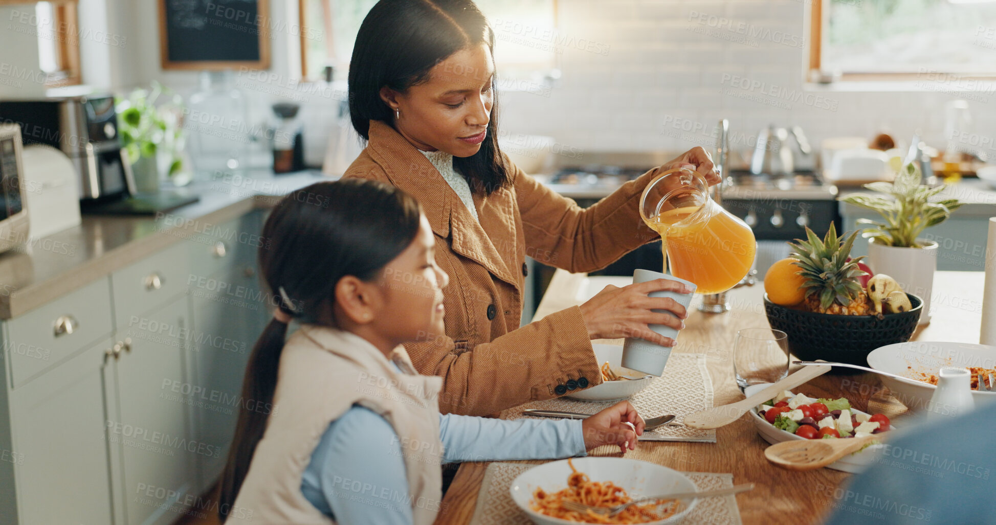 Buy stock photo Woman, girl and juice with family and eating together in kitchen, nutrition and bonding with food. People at home, hungry and female child excited with drink and wellness happy with dinner meal