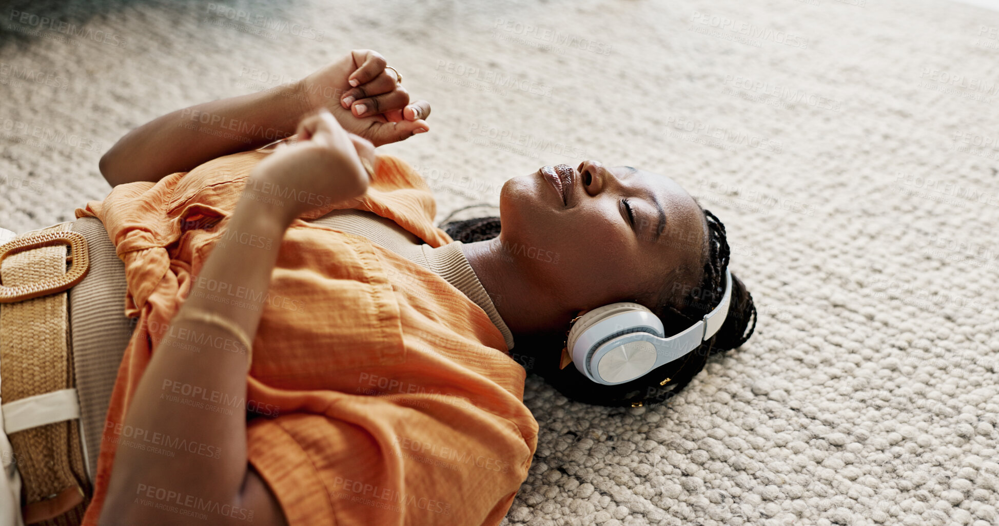 Buy stock photo Headphones, relax and young woman on the floor in the living room listening to music or radio at modern apartment. Dancing, smile and young African female person streaming song in the lounge at home.