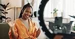 Wave, live streaming and happy black woman with box or product in home living room. Hello, influencer and person with package, record video on social media and content creation, ring light and phone