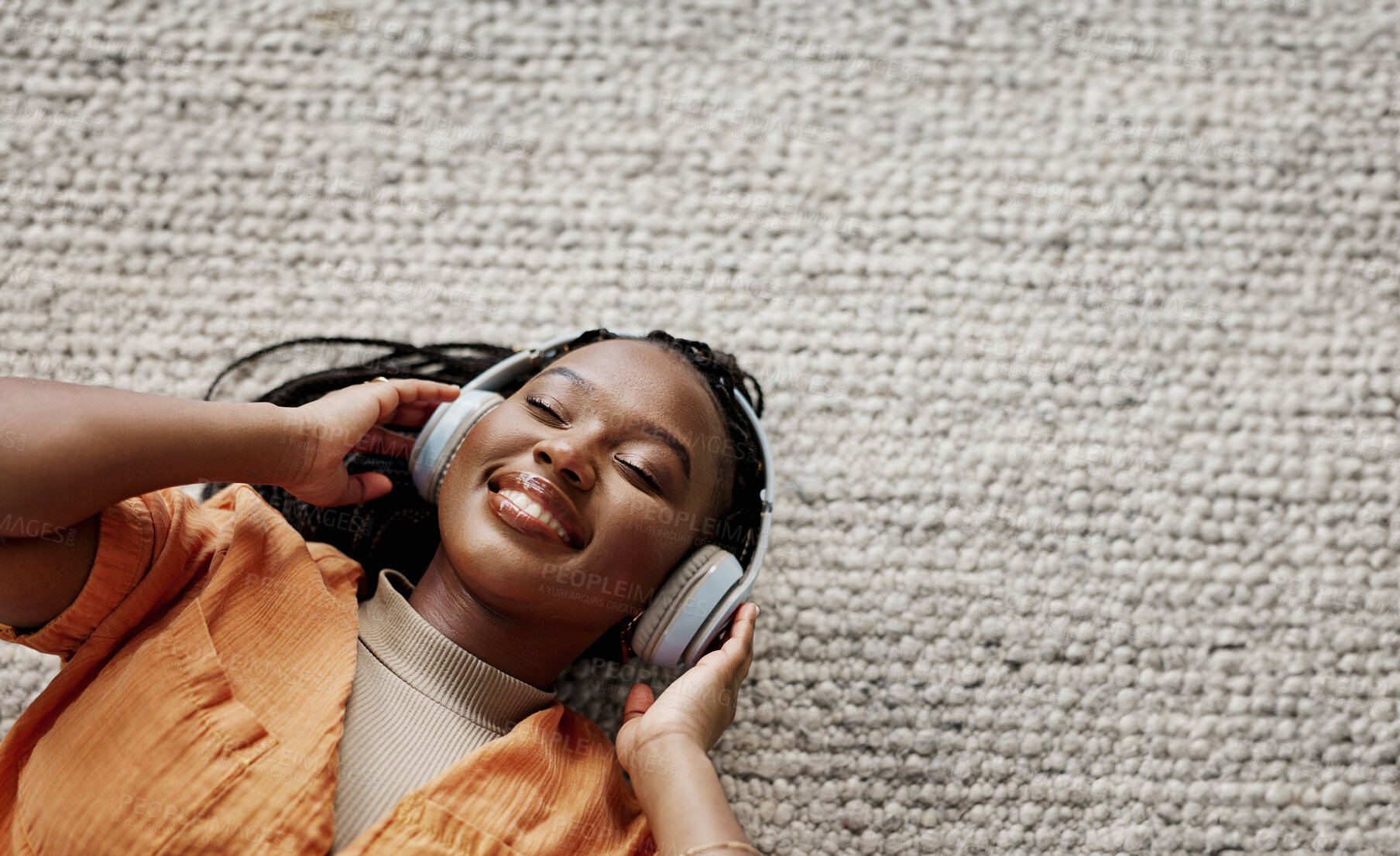 Buy stock photo Home, music and black woman on a couch, headphones and streaming audio in a living room. African person on a sofa, apartment or girl with headset, listening to sound and relax with happiness or song