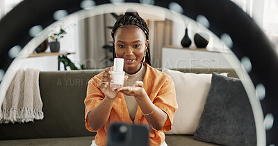 Smile, live streaming and black woman with serum for beauty and open skincare box. Happy, influencer and cosmetics, review product and content creation on social media, ring light and phone at home