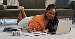 Laptop, happy and woman writing notes on the floor in the living room of modern apartment. Technology, smile and young African female university student studying on a computer in the lounge at home.