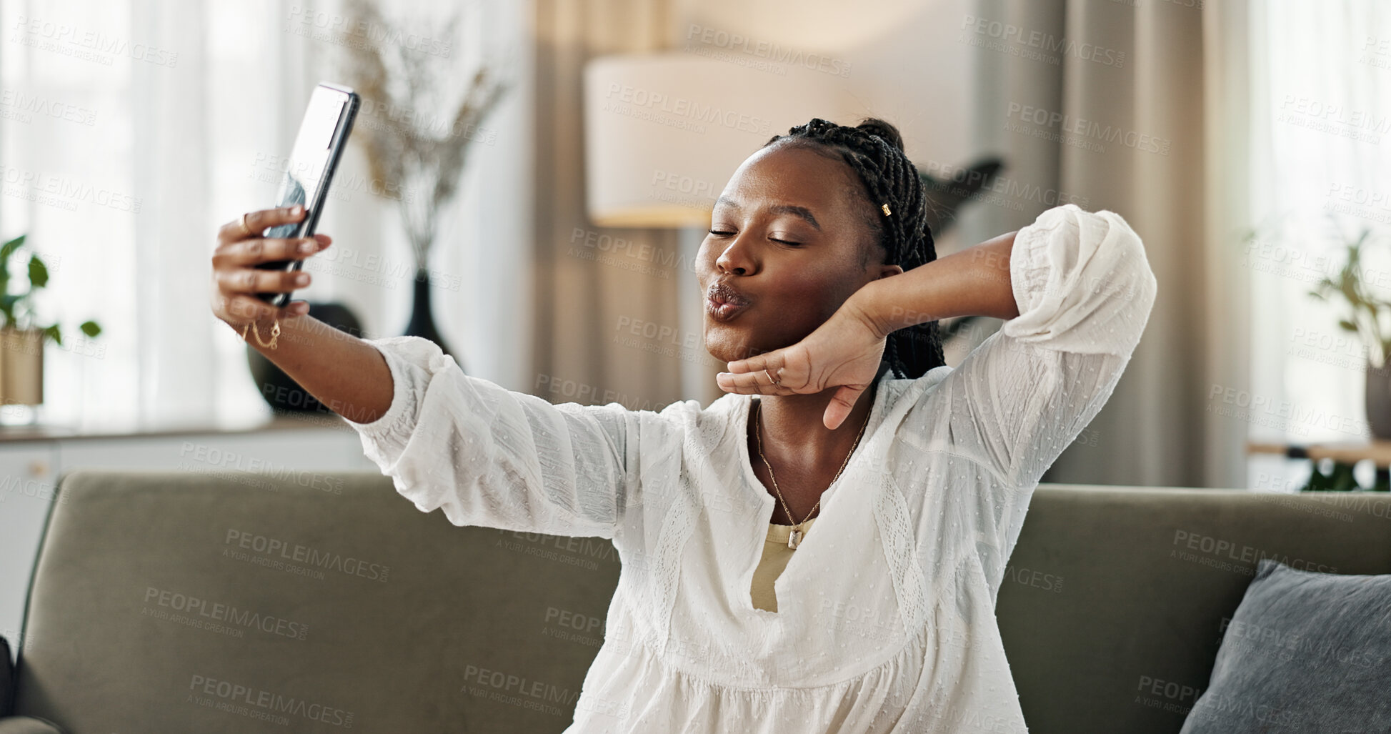 Buy stock photo Smile, selfie and black woman with peace sign, funny face and relax on sofa in living room. V hand, picture and happy African person or influencer at home on couch on social media with tongue out