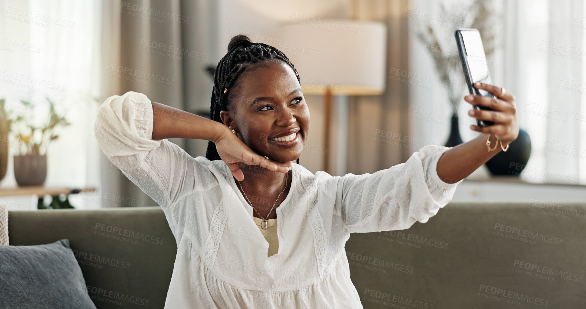 Buy stock photo Smile, selfie and black woman with peace sign, funny face and relax on sofa in living room. V hand, picture and happy African person or influencer at home on couch on social media with tongue out