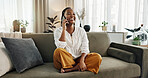 Funny, phone call and black woman on sofa, talking or communication at home. Smartphone, conversation and African person laughing, listening to story and comedy, chat or news and happy in living room