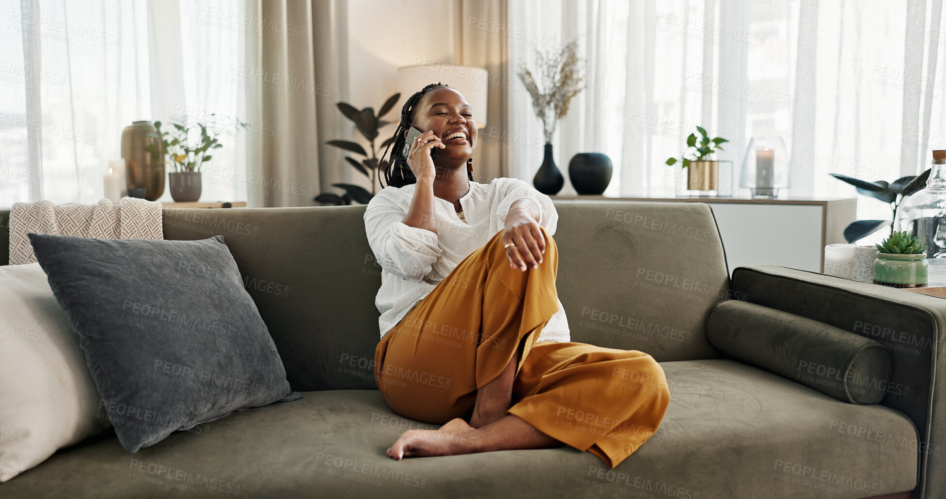 Buy stock photo Black woman on sofa, relax and phone call for good news, conversation and connection with smile in home. Happy girl on couch with smartphone, funny discussion and online chat in living room of house