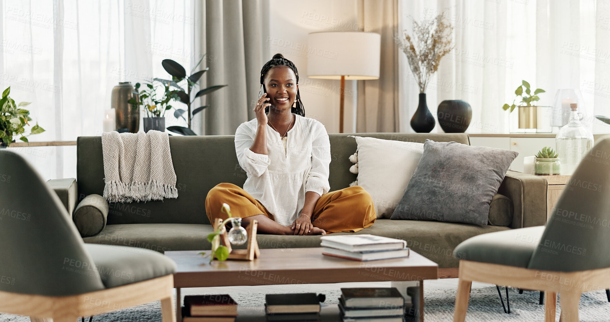 Buy stock photo Black woman on sofa, relax and phone call for good news, conversation and connection with smile in home. Happy girl on couch with smartphone, funny discussion and online chat in living room of house