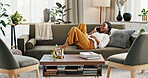 Phone call, laugh and black woman on sofa for talking, funny conversation and online discussion. Networking, communication and person relax on smartphone with humor, joke and comedy chat in home