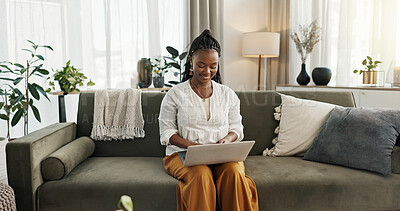 Black woman on sofa, smile and typing on laptop for remote work, social media or blog post research in home. Happy girl on sofa with computer checking email, website or online chat in living room.