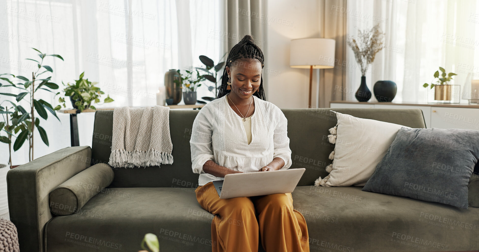 Buy stock photo Black woman on sofa, smile and typing on laptop for remote work, social media or blog post research in home. Happy girl on sofa with computer checking email, website or online chat in living room.