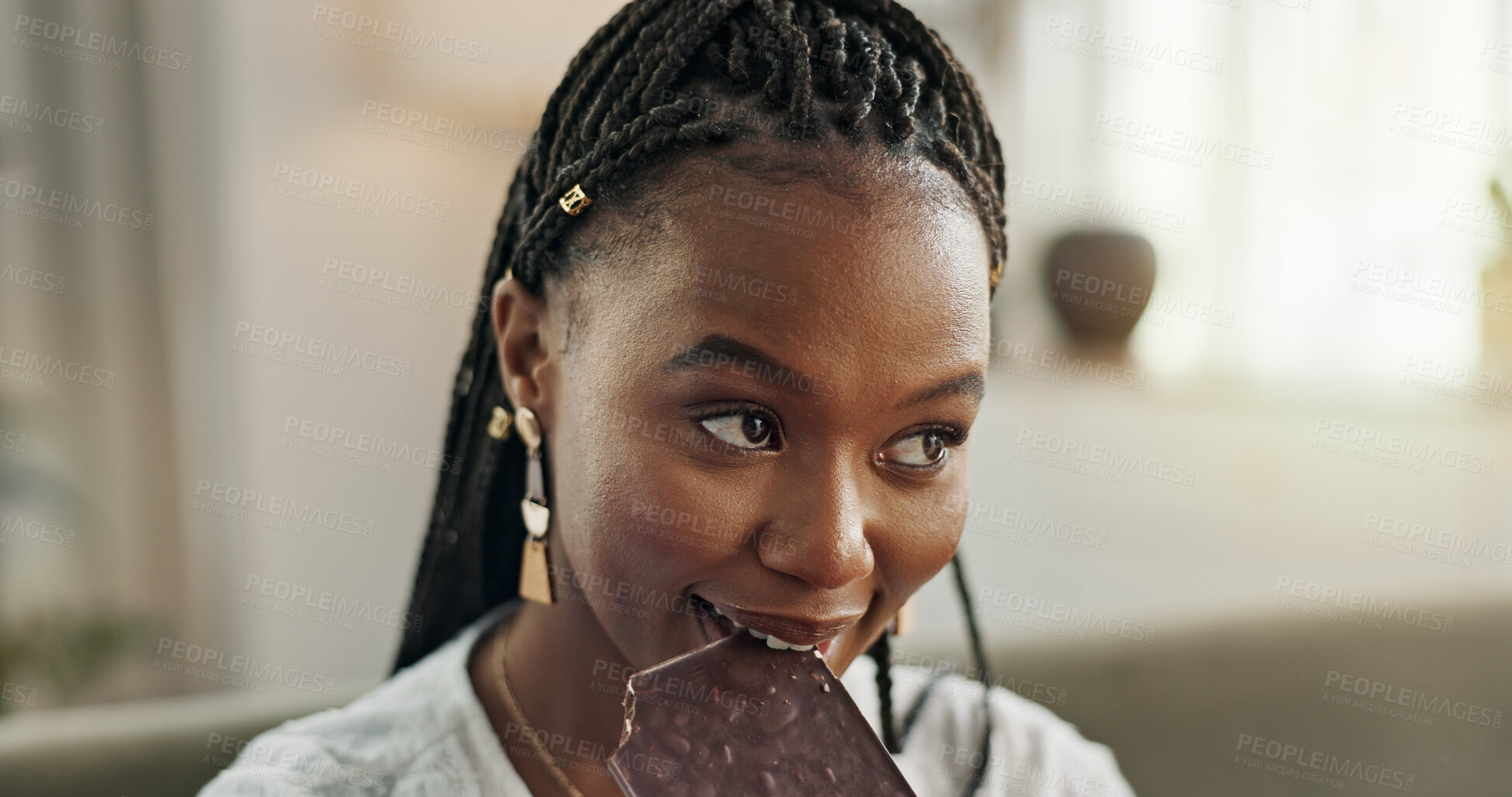 Buy stock photo Home, eating and black woman on sofa, chocolate bar and dessert with happiness, relax and sugar snack in a lounge. African person, apartment or girl with candy, relaxing and dessert with comfort food