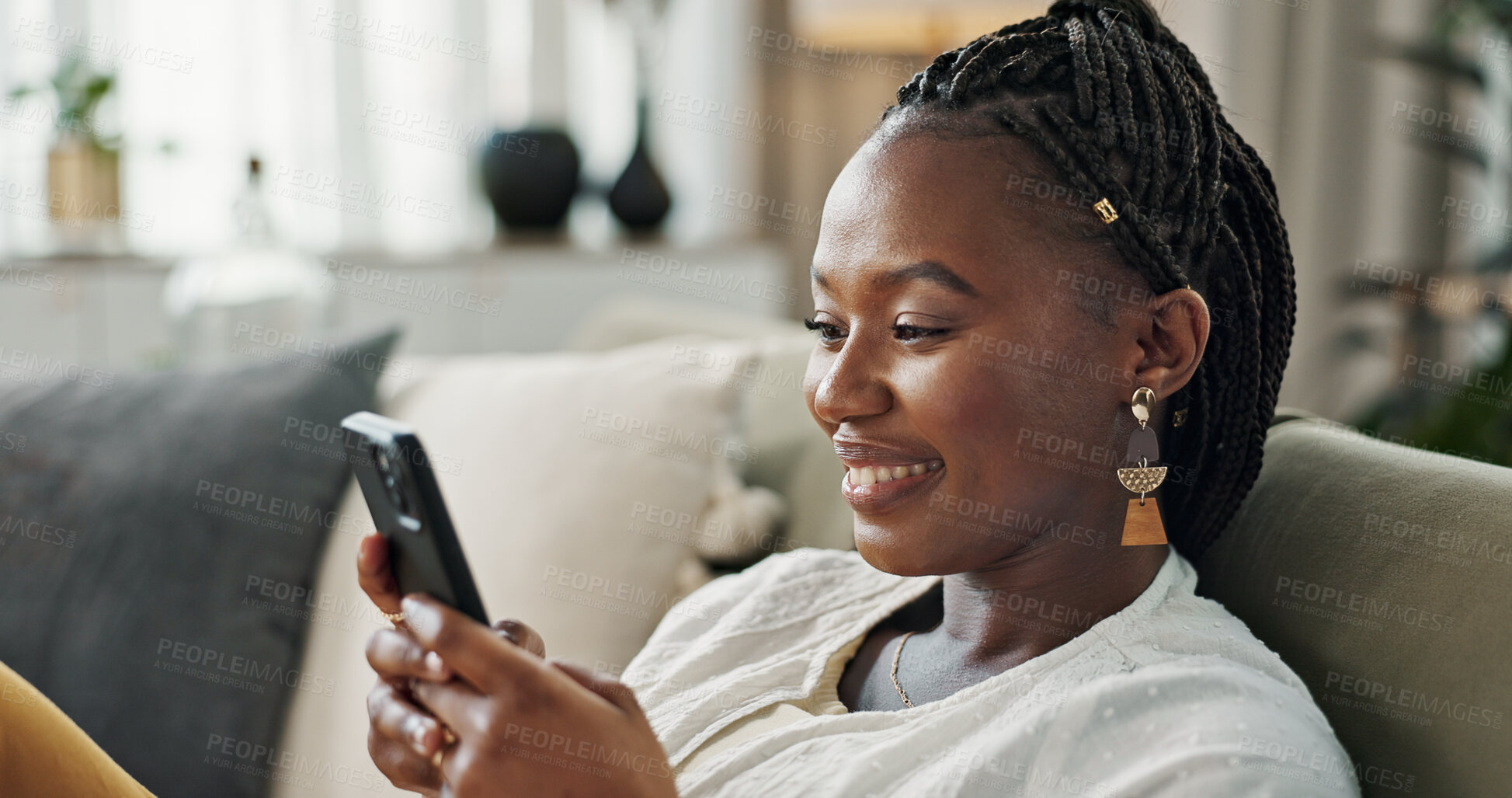 Buy stock photo Funny, smile and black woman on a couch, cellphone or connection with social media, comedy post or laugh. African person, apartment or girl on sofa, smartphone or mobile user with humor, home or joke