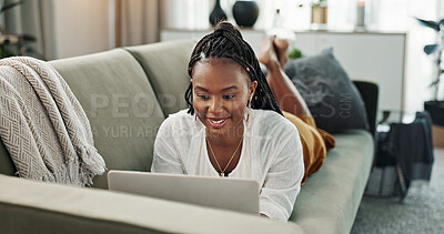 Black woman on sofa, relax or typing on laptop for remote work, social media or blog post research with smile in home. Happy girl on sofa with computer checking email, website or online chat in house