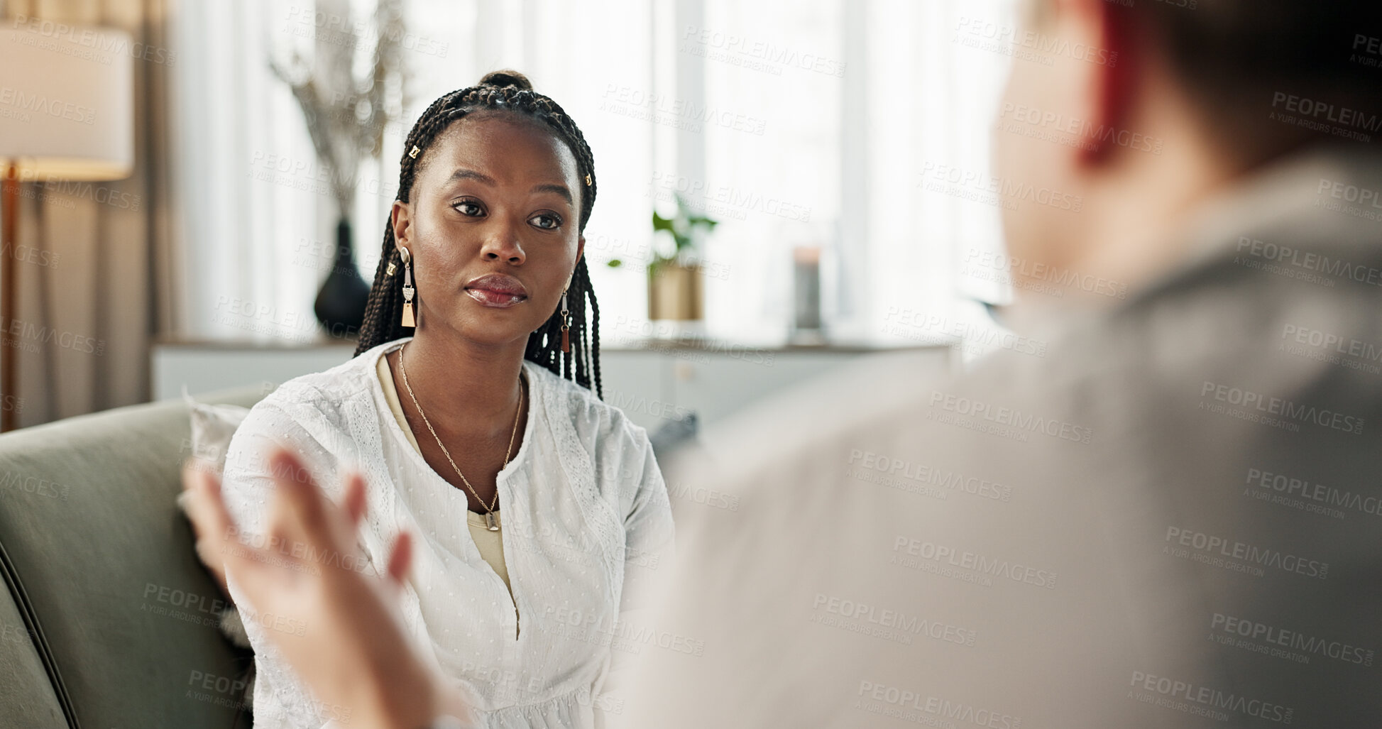 Buy stock photo Office, anxiety and black woman with a therapist, conversation and healing with rehabilitation. African person on a couch, girl and psychologist with advice, help and discussion with depression