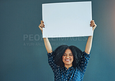 Buy stock photo Poster, mockup and portrait of happy woman in studio with banner for news, social media or advertising on blue background. Space, sign and female smile with paper, board and branding promotion