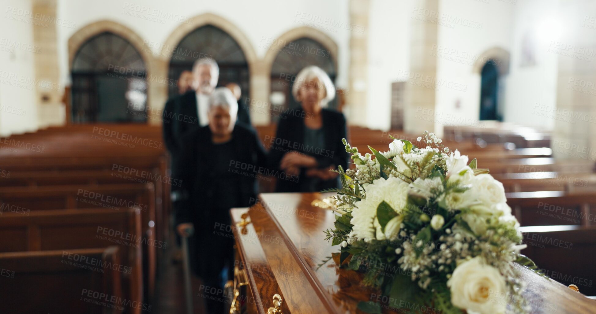 Buy stock photo Funeral, church and people or coffin with flowers for goodbye, mourning and grief at memorial service. Farewell, family and sad senior women or casket in chapel for greeting, loss or burial for death