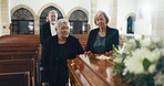 Senior women, coffin and funeral in church for memory, support and condolences with religion with family. Community, friends and together for death, loss and service with empathy, faith and casket
